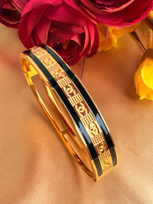 Gold-and-black enamel hinged bangle bracelet